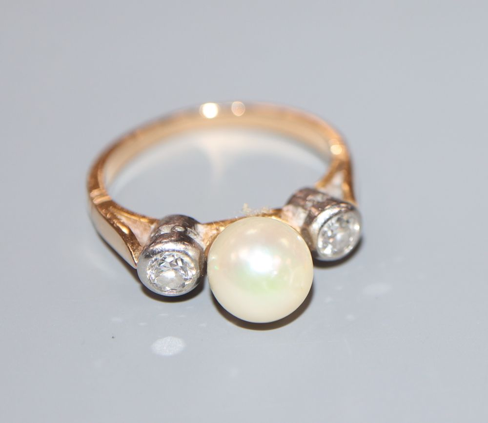 A yellow metal, single cultured pearl and two stone diamond ring, size K/L, gross 3.9 grams.